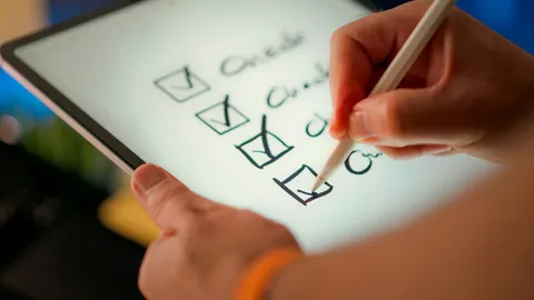 A hand ticking items on a checklist
