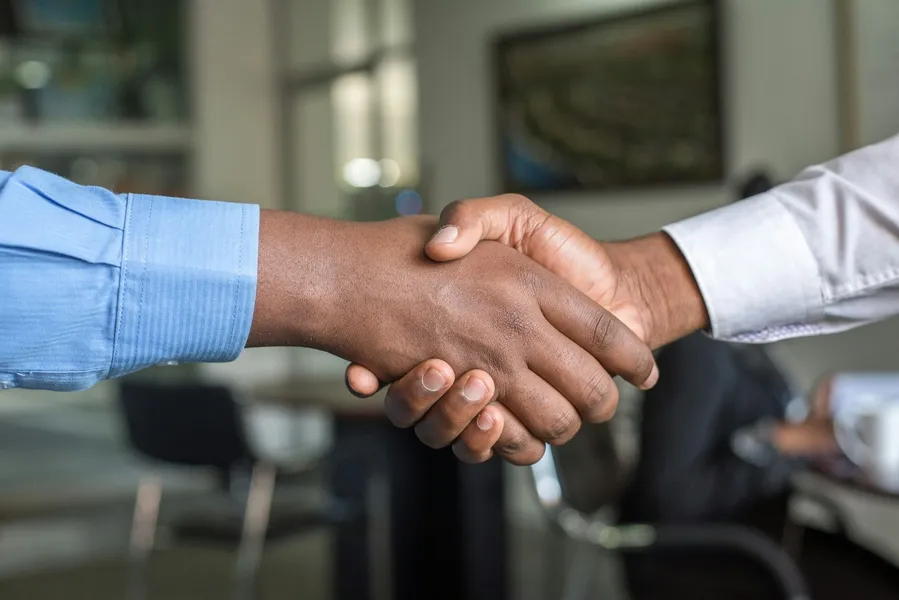 Two people shaking hands after a meeting