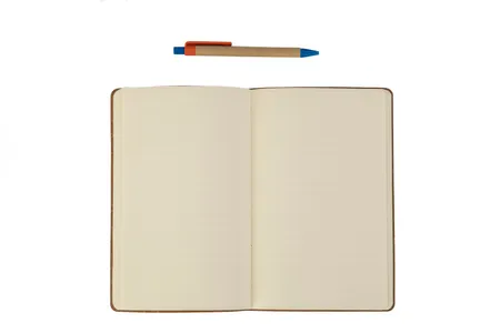 An open notebook and pen on a plain background