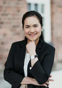 A smiling professional in a black blazer