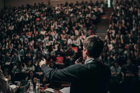 A speaker addressing a large audience