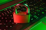 A red padlock on a computer keyboard